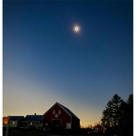 Photo of the 2024 eclipse in Kingfield Maine over the Red Barn Upcycled Market on Route 27 near Sugarloaf ski area.